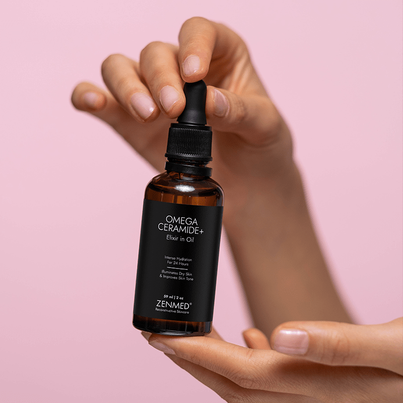 Hand holding ZENMED OMEGACERAMIDE+ Elixir in Oil